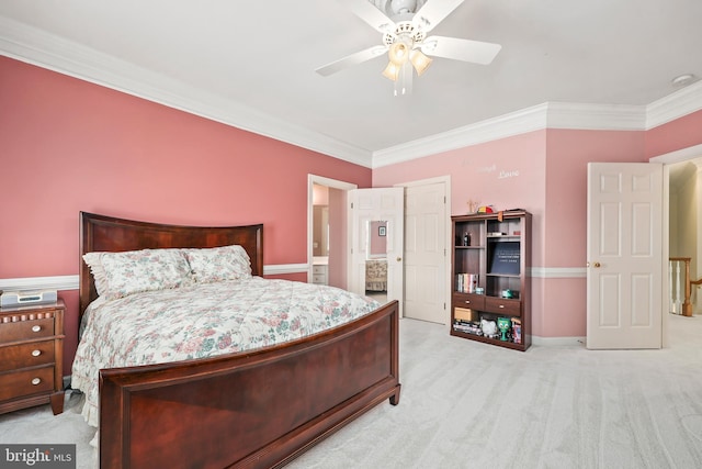 carpeted bedroom featuring ceiling fan, ensuite bath, and ornamental molding