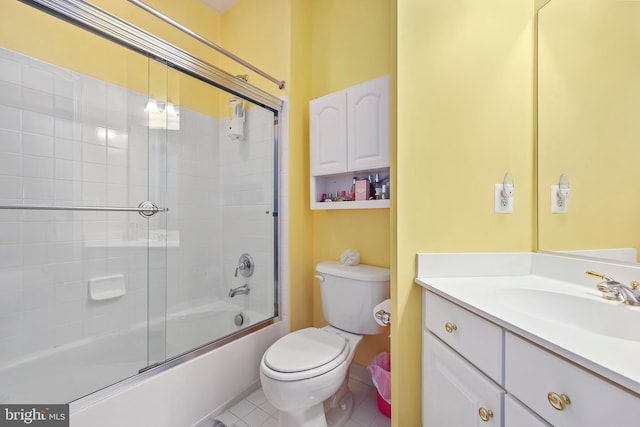 full bathroom featuring toilet, vanity, tile patterned flooring, and shower / bath combination with glass door