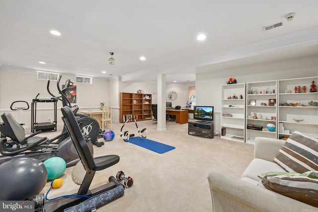 workout room with light colored carpet and crown molding