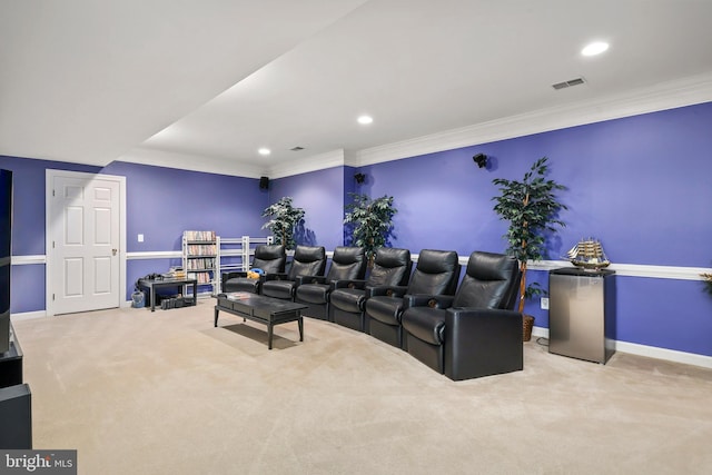 carpeted home theater room with ornamental molding