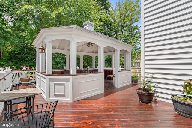 wooden deck featuring a gazebo and a bar