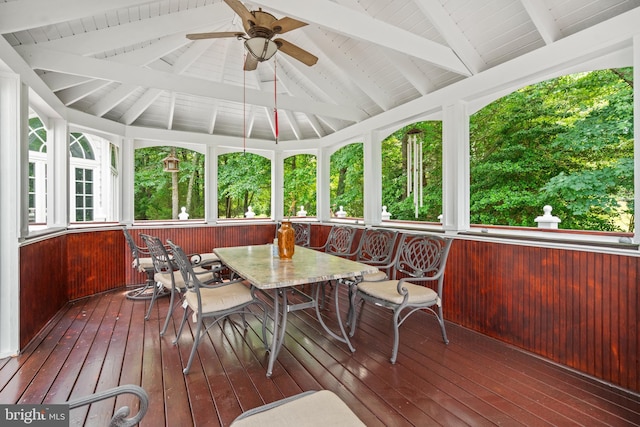 sunroom with ceiling fan and lofted ceiling with beams