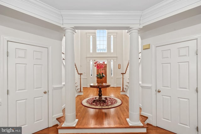 entrance foyer featuring ornamental molding and light hardwood / wood-style flooring