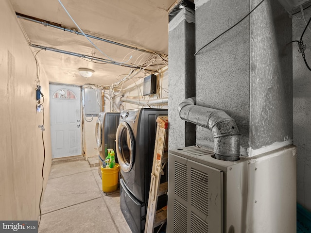 clothes washing area featuring heating unit and washing machine and clothes dryer