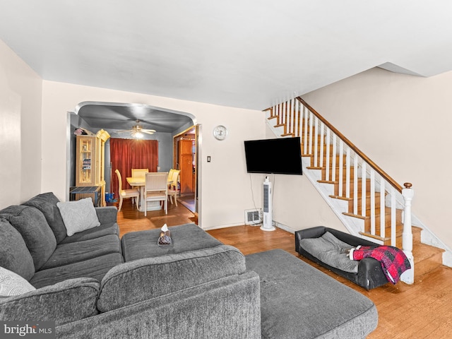 living room featuring ceiling fan and hardwood / wood-style floors