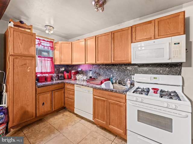 kitchen with light tile patterned floors, sink, tasteful backsplash, and white appliances