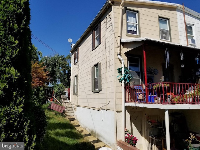 view of side of property with cooling unit