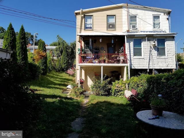 back of property featuring a lawn