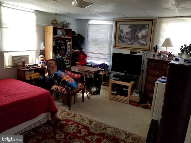 bedroom with a paneled ceiling, carpet, and cooling unit