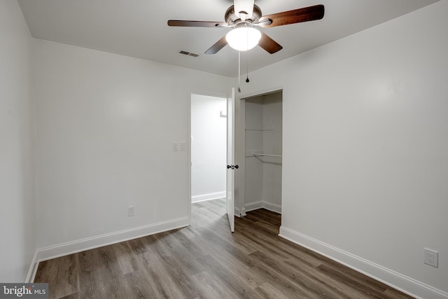 unfurnished bedroom featuring ceiling fan, a closet, and light hardwood / wood-style flooring