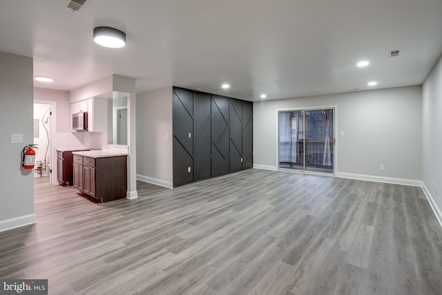 unfurnished living room featuring light wood-type flooring