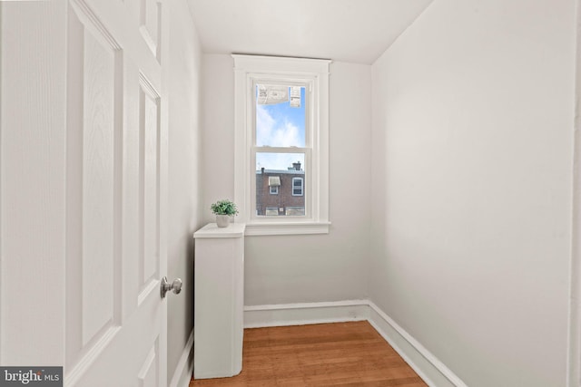 laundry room with hardwood / wood-style flooring