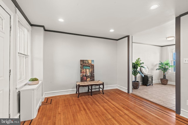 interior space with ornamental molding and light hardwood / wood-style flooring