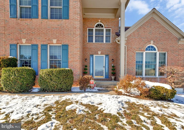 view of snow covered property entrance