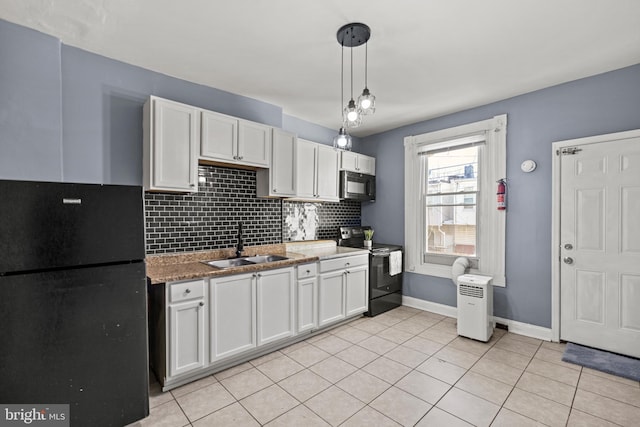 kitchen featuring pendant lighting, black appliances, decorative backsplash, sink, and white cabinetry