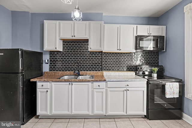 kitchen featuring light tile patterned floors, white cabinetry, sink, and black appliances