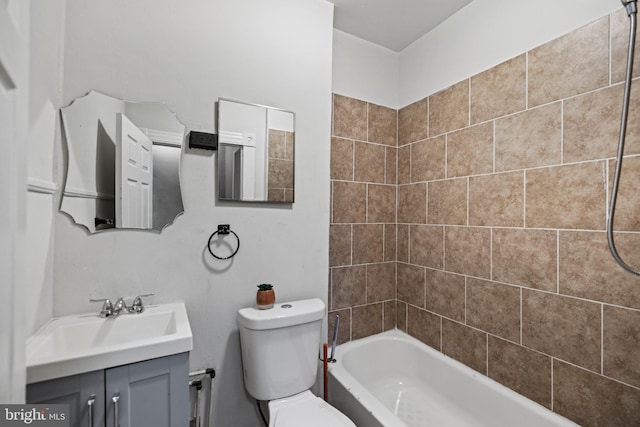 full bathroom featuring toilet, vanity, and tiled shower / bath