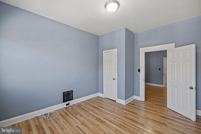 unfurnished bedroom with light hardwood / wood-style floors and a closet