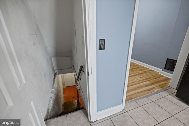 stairway featuring tile patterned flooring