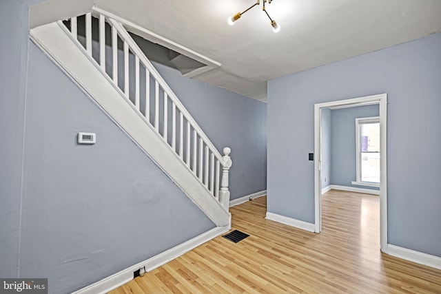 entrance foyer with a chandelier and light hardwood / wood-style floors