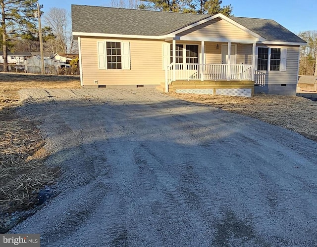 view of front facade featuring crawl space, a shingled roof, and a porch