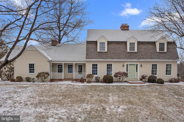 new england style home with covered porch