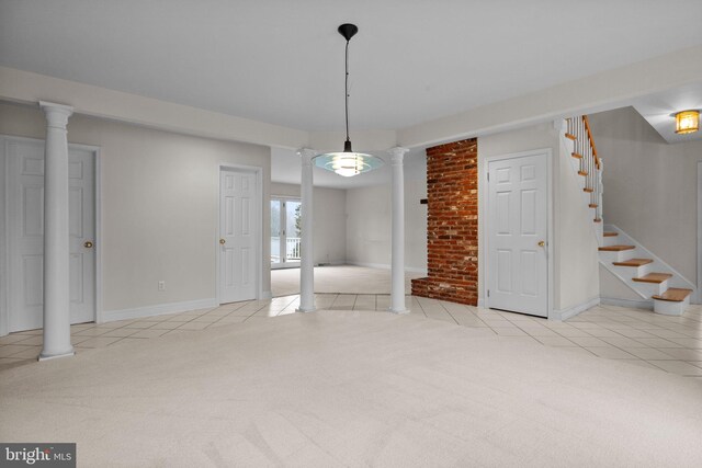 unfurnished dining area with decorative columns and light colored carpet