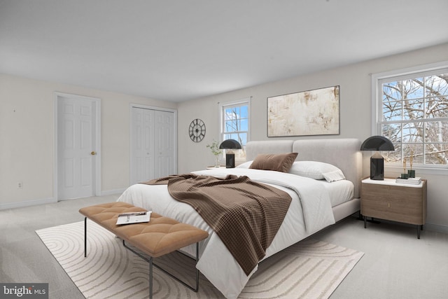 bedroom featuring light colored carpet and multiple windows