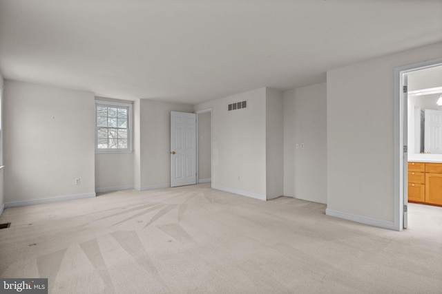 unfurnished room featuring light carpet