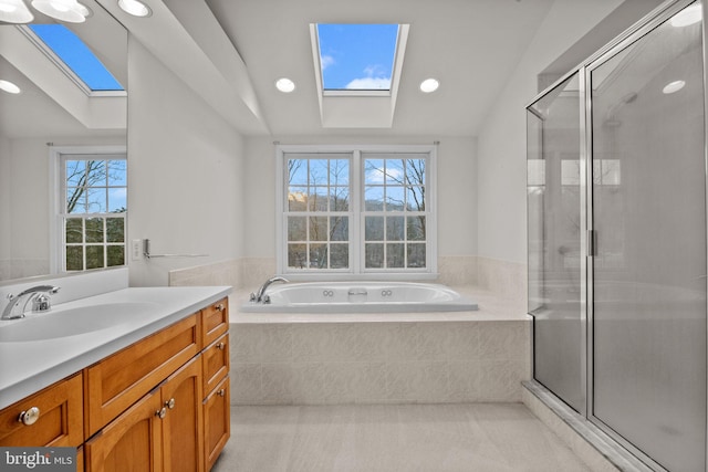 bathroom featuring independent shower and bath, lofted ceiling with skylight, and plenty of natural light