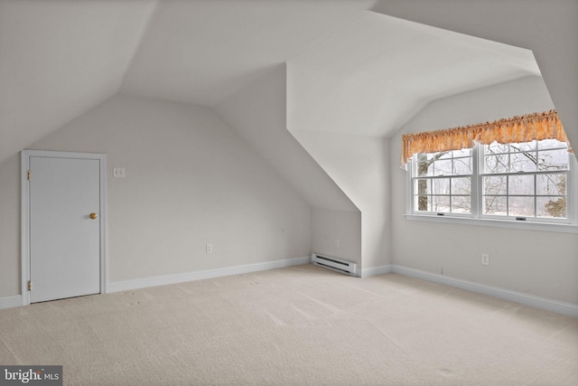 additional living space featuring vaulted ceiling, a baseboard radiator, and light carpet