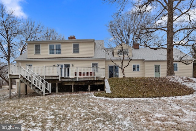 snow covered property featuring a wooden deck