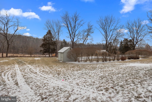 snowy yard featuring an outbuilding