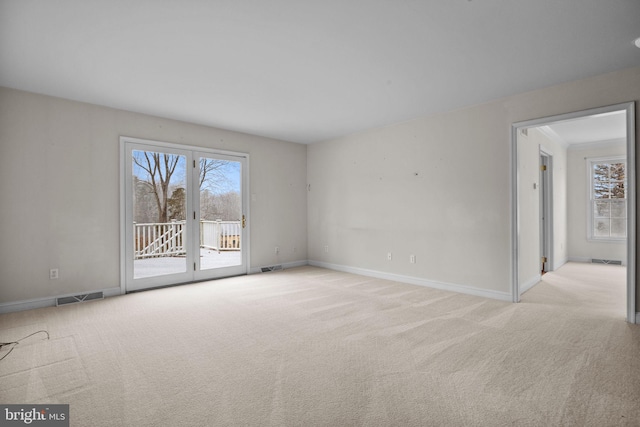 spare room featuring light carpet