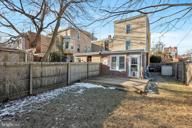 snow covered property featuring a yard and a wooden deck