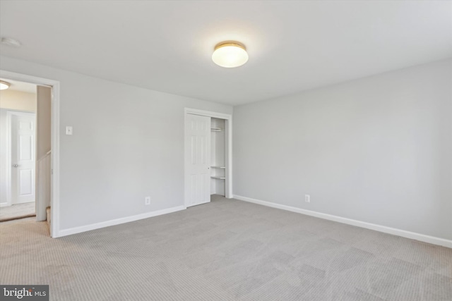 spare room featuring light colored carpet