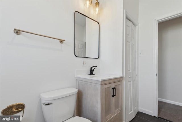 bathroom with toilet and vanity