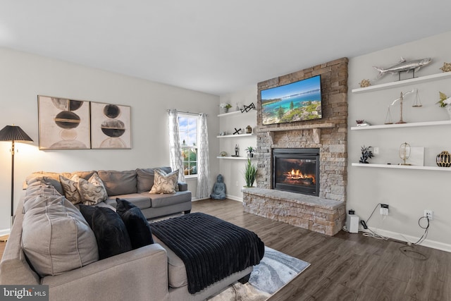 living room featuring a stone fireplace and hardwood / wood-style flooring