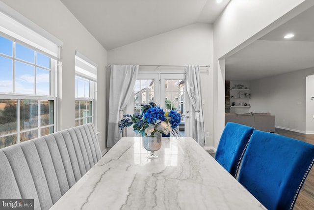 dining area with lofted ceiling and hardwood / wood-style flooring