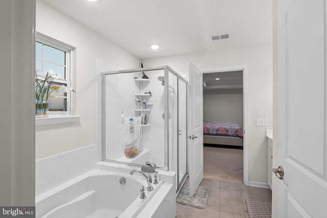 bathroom with tile patterned floors, vanity, and shower with separate bathtub