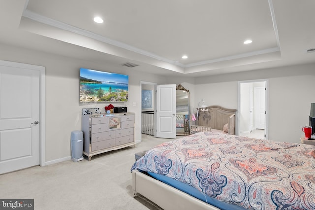 bedroom with crown molding, a tray ceiling, and light carpet