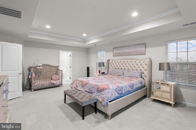 carpeted bedroom featuring crown molding and a raised ceiling