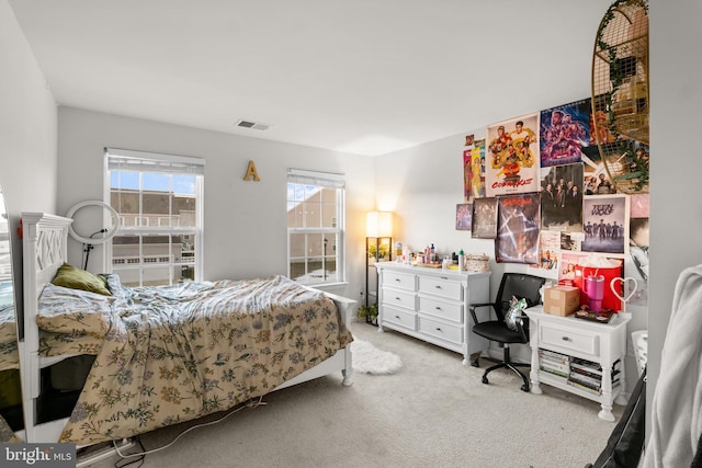 bedroom with light colored carpet