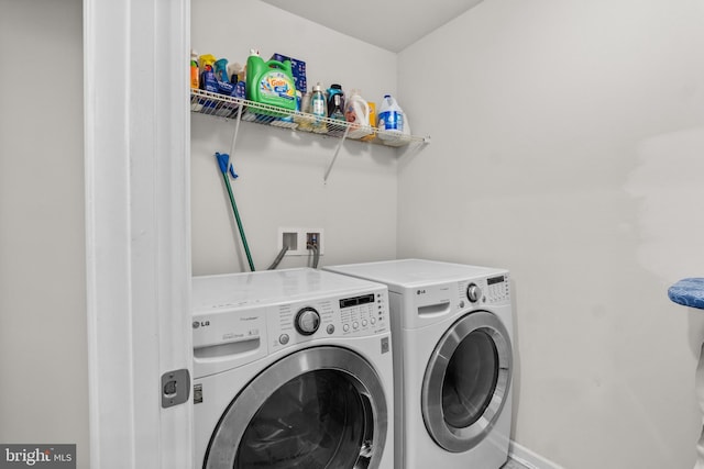 laundry room with washing machine and clothes dryer