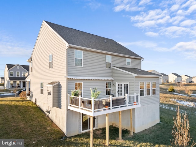 back of house featuring a lawn