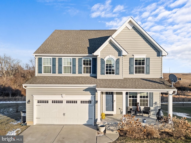 view of front property featuring a porch and a garage