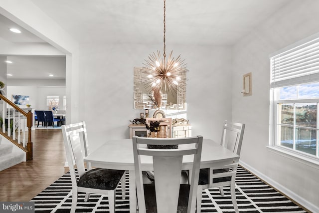 dining area featuring a chandelier and dark hardwood / wood-style flooring