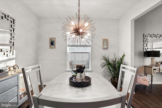 dining area with dark hardwood / wood-style floors and a chandelier