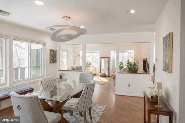 dining area featuring baseboards, wood finished floors, visible vents, and recessed lighting