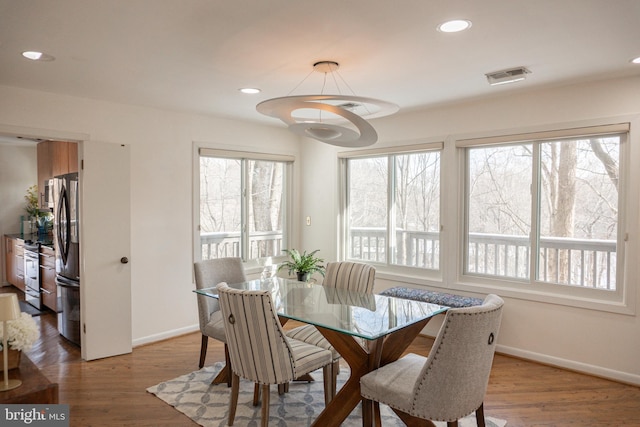 dining area with recessed lighting, visible vents, baseboards, and wood finished floors